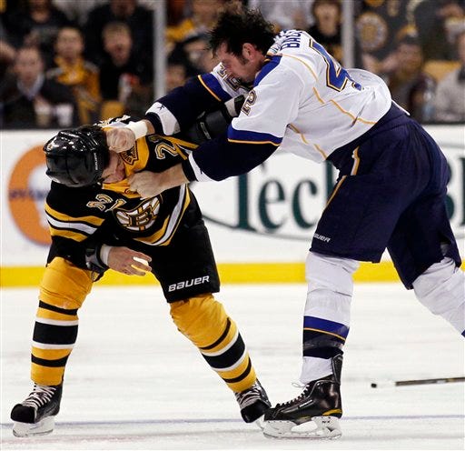 Andrew Ference fights with St. Louis Blues center David Backes, right, on Saturday night at TD Garden.