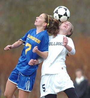Hanover's Karly Atturio (7) and Rockland's Melissa Daigle head the ball at midfield in the first half during Hanover's 1-0 victory on Saturday in a Div. 3 South Sectional first-round soccer match.