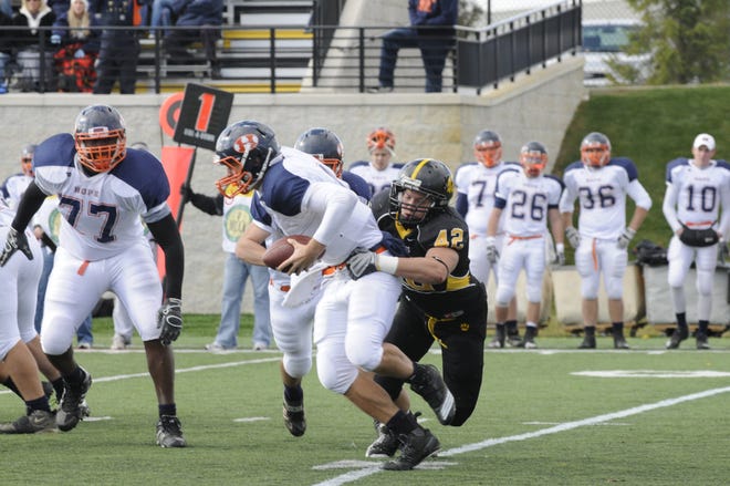 Hope College quarterback Chris Feys is sacked by Adrian College Saturday.