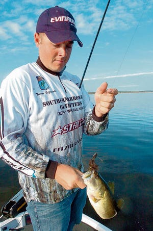 Trevor Fitzgerald, a deputy sheriff, catches a bass in Orange Lake at sunrise on Nov. 1. Fitzgerald recently won the 2010 Bass Pro Shops Bassmaster Southern Open held in Georgia. “I really didn't get into this expecting the amount of success I've had,” he said.