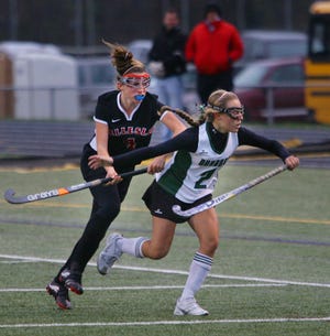 Wellesley's Tali Peretti, left, and Duxbury's Molly Zaverucha pursue the ball during the Dragons' 2-0 loss on Sunday in a Div.1 South Sectional field hockey match.