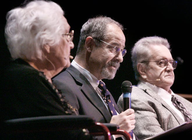 Ted Gup's speaks with decendants of the letters during the presentation of his book "The Secret Gift" at the Palace Theatre Friday. At left is Betty Snively.