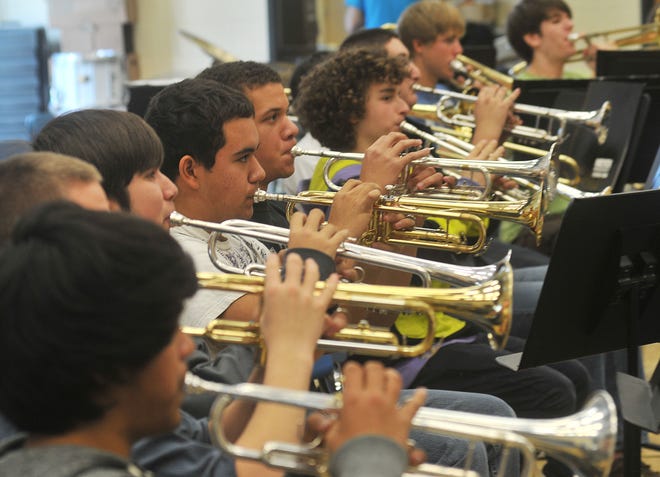 West Ottawa's band rehearses Monday afternoon at West Ottawa High. West Ottawa's music department is a finalist for a GRAMMY Signature School Award which will recognize the schools exemplary music program.