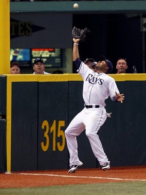 Tampa Bay Rays' Carl Crawford makes a catch against the wall on a fly ball by Boston Red Sox's Mike Cameron during the second inning of a baseball game Tuesday, May 25, 2010, in St. Petersburg, Fla. Crawford was ejected in the fifth inning for arguing balls and strikes in a 2-0 loss to the Red Sox.