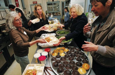 Photo by Daniel Freel/New Jersey Herald 
From left, Michele Smith, of Coupons for the Community, Dawn Metzgar and Brigitte Walsh, both of the Samaritan Inn, and volunteer Christine Dimauro work together to prepare meal trays during a “Cooking with Coupons” course at the Manna House, in Newton, Tuesday.