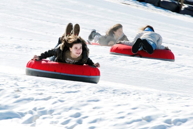 Heather Hughes, 13, of Utica makes her way down the tubing hill at Val Bialas, Monday, February 16, 2009 in Utica. Friends Kennedy DeBernardis of Yorkville and Santina Blair of Utica, both 13, can be seen in the background.