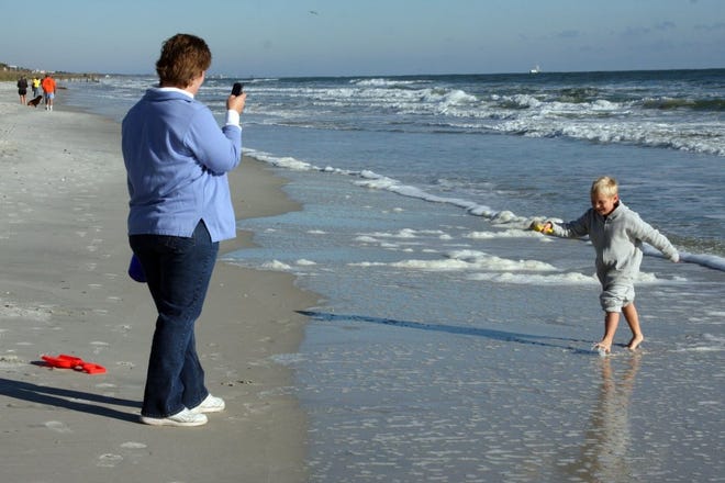 Ian Morgan, 5, frolics in the surf in Atlantic Beach on Saturday as his mother Kimberly Morgan takes his picture for the Visit Florida website as part of The Great Visit Florida Beach Walk project to promote the beauty of the state's beaches and counteract negative publicity about the Gulf of Mexico oil spill.