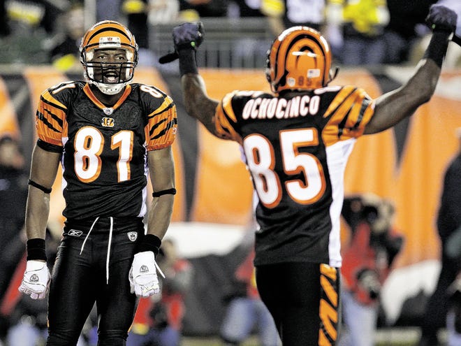 Cincinnati Bengals wide receiver Chad Ochocinco (85) signals a touchdown after wide receiver Terrell Owens (81) scored on a 19-yard pass reception in the first half of an NFL football game against the Pittsburgh Steelers, Monday, Nov. 8, 2010, in Cincinnati.