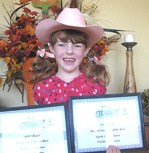 Nine-year-old Hannah Richardson of Waynesboro holds her first place awards from the Tennessee Country Music Association talent competition in Pigeon Forge this past weekend.