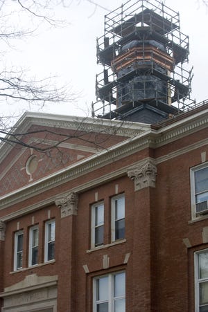 As construction takes place at Whitman Town Hall, the cupola is cloaked in scaffolding.