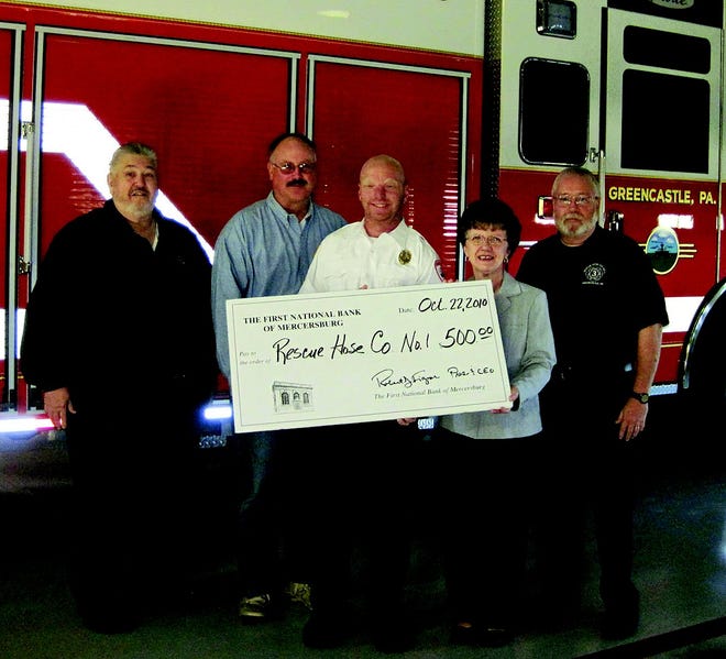 On behalf of The First National Bank of Mercersburg, Greencastle Office Manager Sara Hollenshead presents a donation to Rescue Hose Co. No. 1. Accepting for the Rescue Hose Company are Trustee Ron Nicarry, Treasurer Frank Klink, President Shannon Hummer and Administrator Brian Barkdoll.