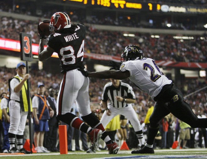 DAVID GOLDMAN/Associated PressFalcons receiver Roddy White (84) catches a touchdown pass as Ravens safety Ed Reed defends during the fourth quarter on Thursday night in Atlanta.