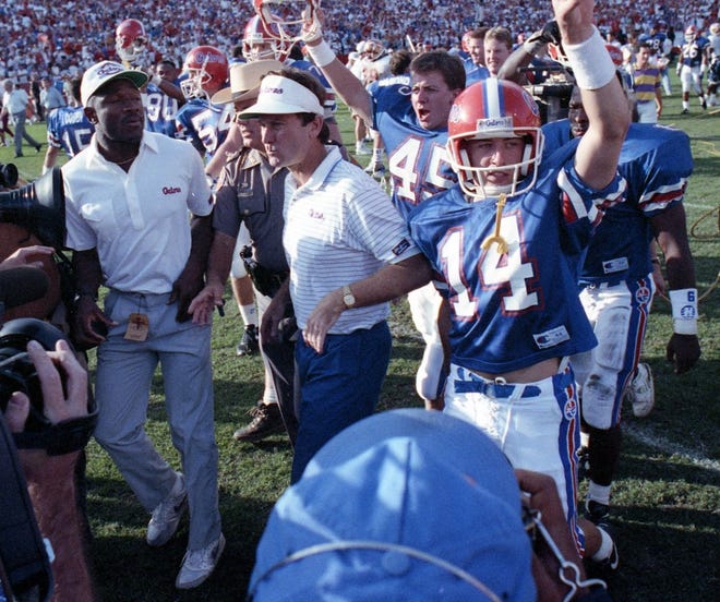 Spurrier (center) and players celebrate the win over FSU in 1991.