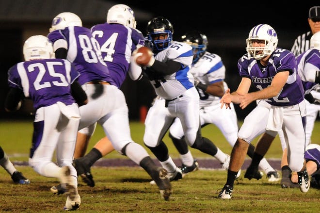 Fletcher's Sam Wood pitches the ball to Mitchell Hester in the first quarter of the Senators' Nov. 5 game against First Coast. Fletcher High lost the district title contest 27-15.