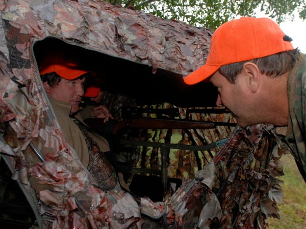 Bill Emigh (left) is helped into a deer blind by his son, Austin (in background) and Alan Gregory. Emigh was participating in the North Carolina Handicapped Sportsmen Inc. deer hunt at Watha.