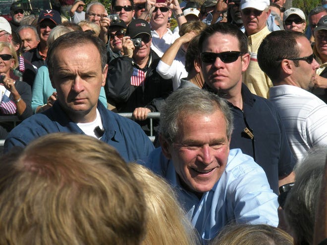 Former President George W. Bush, center, greets supporters during a rally to support his new memoir Saturday at The Villages. (The Associated Press)