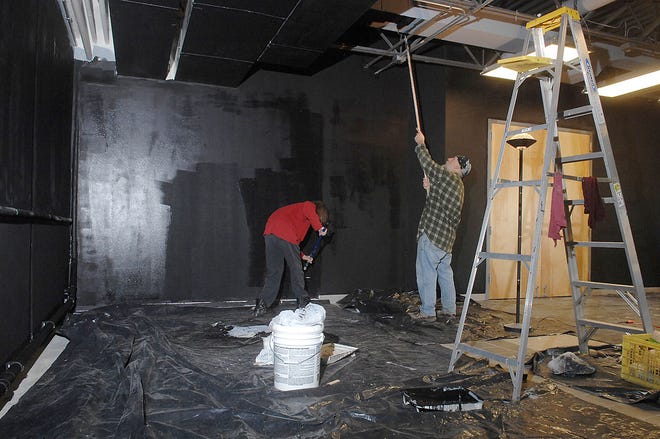 Bruce Watts, left, and LR Hults paint the interior of the new Berlin Theatre. The space, which will serve as a home for Theatre NXS, is located next to Berlin Café at 220 N. Tenth St.