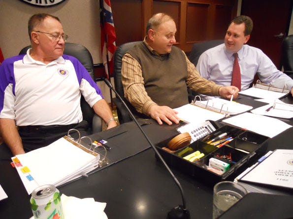 Jackson trustees, Bill Burger, John Pizzino and Jamie Walters review department budgets for the fiscal year 2011.
