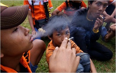 Indonesian boys smoke ahead of a soccer match in Jakarta. Indonesia is not a signatory to any global treaty on smoking.