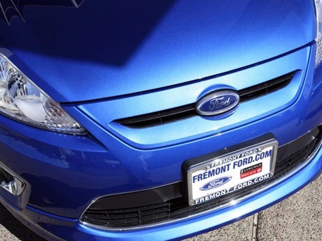 A 2011 FORD FIESTA sits on the lot of Fremont Ford in Newark, Calif. Retail sales were boosted last month by strong demand for autos, reaching their highest levels in seven months.