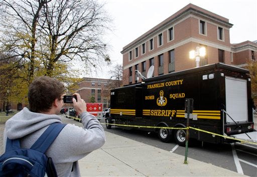 Ohio State student Derek Ludwig, of Pickerington, takes a picture of the bomb squad van with his cell phone during a bomb threat at Ohio State University.