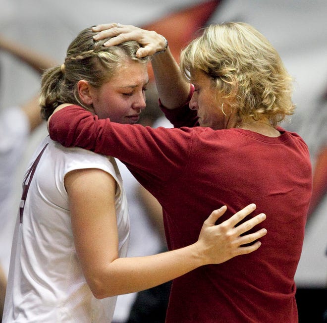 Oak Hall Eagle player Katie O'Meara is consoled by head coach Cari Martin after losing to the Lake Worth Christian Defenders during their 1A FHSAA Volleyball Finals semi-final match at the Lakeland Center in Lakeland, Florida, Wednesday, November 17, 2010.
