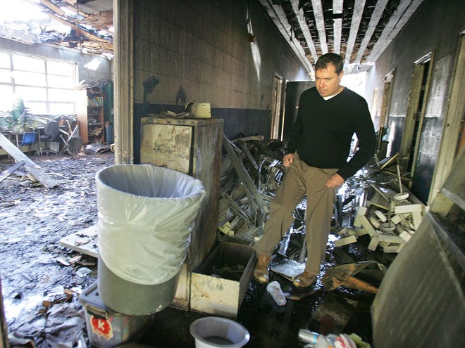 Mike Wich, a South Central Planning and Development Commission building inspector, checks what remains of the fire-damaged St. Matthew’s Episcopal School building.