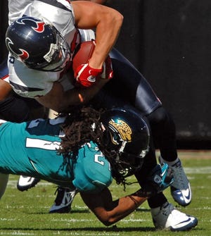 The Jaguars' Rashean Mathis tackles the Texans' Troy Nolan during the first quarter of Sunday's game at EverBank Field.