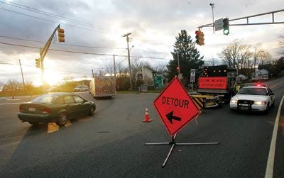 Photo by Daniel Freel/New Jersey Herald - Traffic is diverted south onto State Route 94 at its intersection with State Route 15 in Lafayette Wednesday. High winds caused two utility polls to topple, closing down an entire section of Route 15.