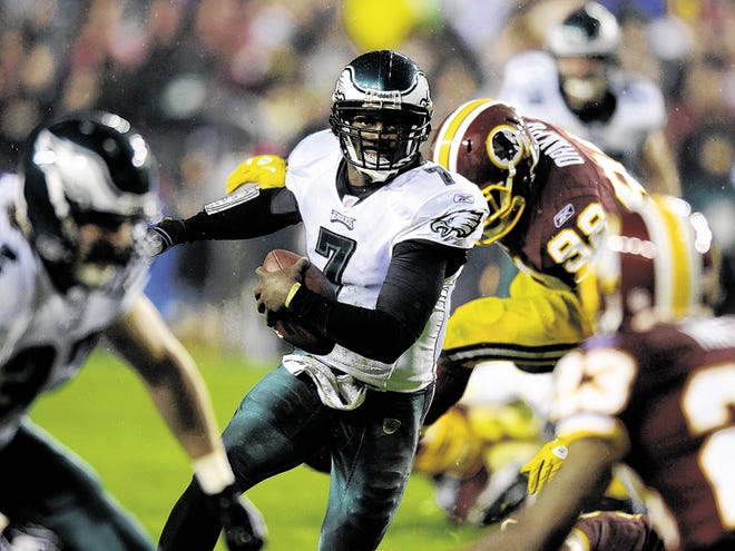 Philadelphia Eagles quarterback Michael Vick (7) rushes during the first half of an NFL football game against the Washington Redskins, Monday, Nov. 15, 2010, in Landover, Md. The Eagles won 59-28.