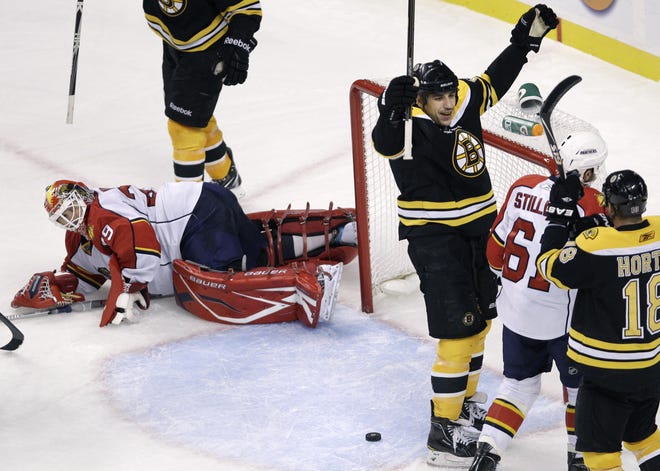 Bruins forward Milan Lucic (arms raised) celebrates after scoring one of his three goals in Boston's 4-0 win over the Lightning.