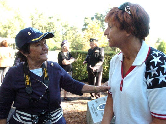 Ruthie Burnham and Christine Gonzalez talk during a meeting between groups in Hernando and Ocala at the Florida National Cemetery in Bushnell on Thursday.