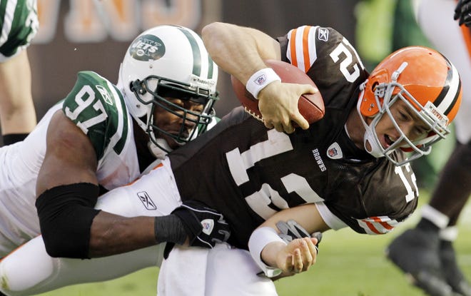 Cleveland Browns quarterback Colt McCoy is sacked by New York Jets linebacker Calvin Pace during Sunday’s game in Cleveland. McCoy took an even harder hit from Bart Scott in the first quarter, but McCoy shrugged it off. “Sometimes it feels good,” McCoy said of the hit. “Your line sees you get hit and you pop back up and then we go down two more plays and score.”