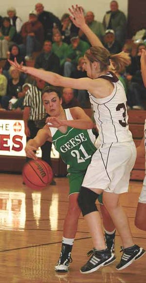 Wethersfield’s Margaret Thomson (21) tries to wrap a bounce pass around a Princeville defender Thursday night. The Lady Geese topped the hosts 46-25.