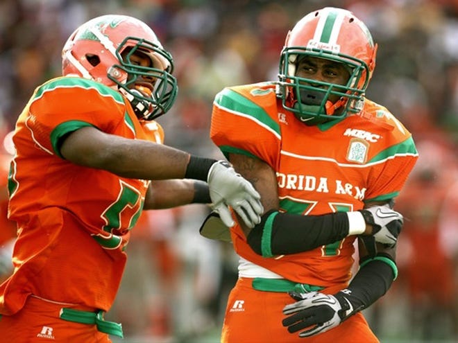 Florida A&M's Alphonso Walker III, left, and Gregory Harvey celebrate a tackle during the Rattlers' 38-27 win in the Florida Classic on Saturday in Orlando.