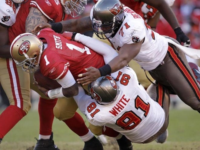 San Francisco quarterback Troy Smith (1) †
is sacked by Tampa Bay Buccaneers defensive end Stylez White (91) and defensive lineman Michael Bennett (71).