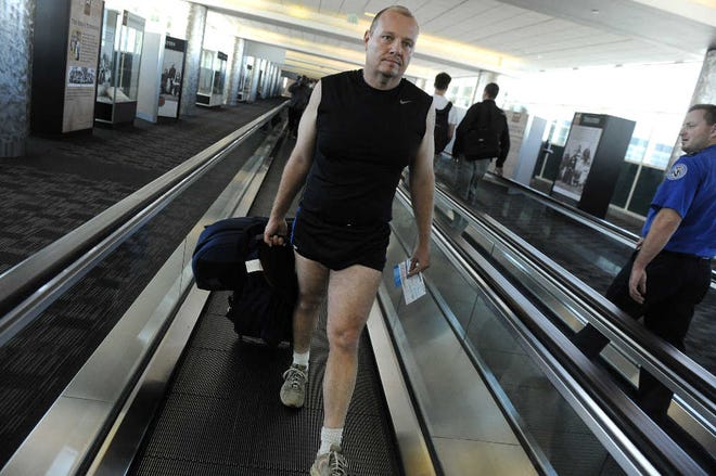 Jeff Gator Henry wears shorts and a T-shirt as he approaches the security area at Denver International Airport. Henry was protesting that some commuters were forced to choose between a full body scan or an enhanced pat-down.