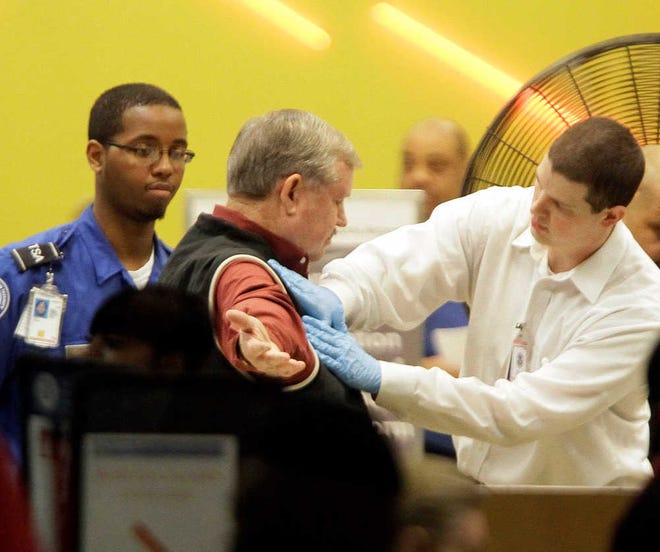 A passenger is patted down while going through a security checkpoint at Atlanta's Hartfsield-Jackson International Airport Monday, Nov. 22, 2010, in Atlanta. (AP Photo/David Goldman)