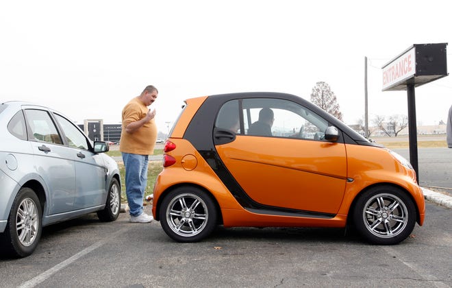 Andy Butt directs Paul and Pege Barnes of Shelbyville as they park their Smart Car horizontally within a vertical parking space during a meeting of Smart Car enthusiasts Saturday, Nov. 20, 2010 at The Lighthouse Restaurant in Springfield. Ted Schurter/The State Journal-Register