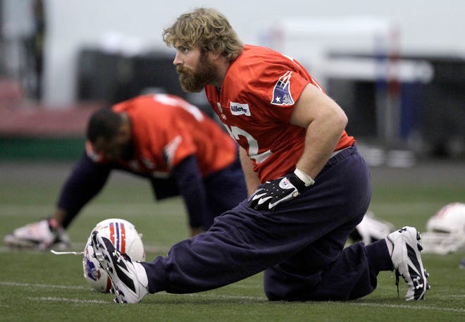 Patriots tackle Matt Light stretches before practice on Tuesday.