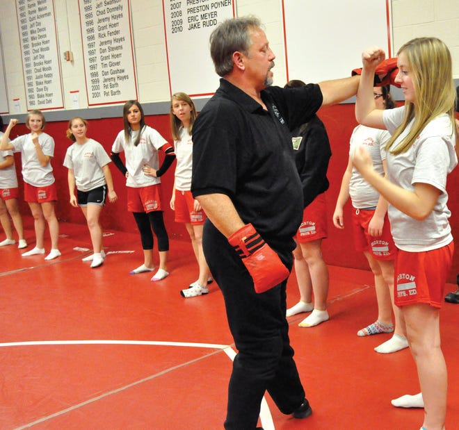 Junior Jana Kotysan defends Sonny Couch’s advances Friday during the final day of training at Morton High School. The junior and senior girls’ gym classes were taught basic defense strategies in the event of an attack.