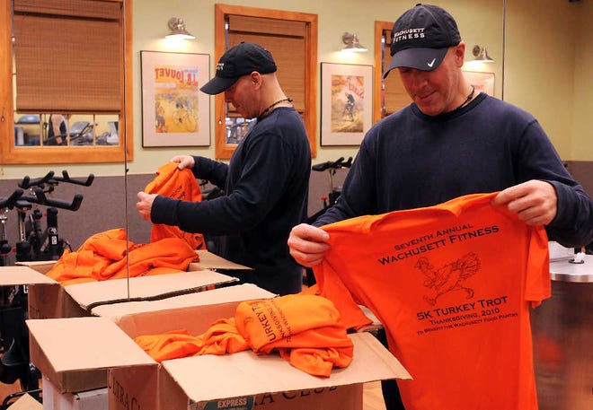 Race director Paul F. Latino unpacks his shirts for the Wachusett Fitness 5K Turkey Trot yesterday. About 1,000 people are expected to participate in the 6-year-old event.