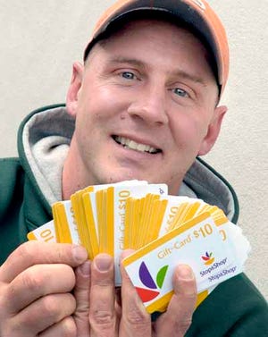 Jeff Sirois shows off a winning hand of Stop & Shop Gift cards from members of the Teamsters local 25 who work at the Stop & Shop warehouse in Freetown.