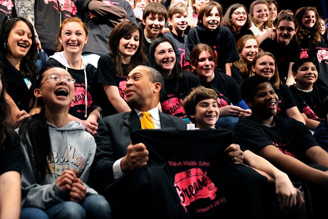 Gov. Deval Patrick sits with the cast of "Grease" at Framingham's Walsh Middle School.