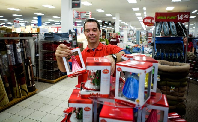JC Penney employee Steve Mayes works on a Black Friday promotion at the company’s Springfield store.