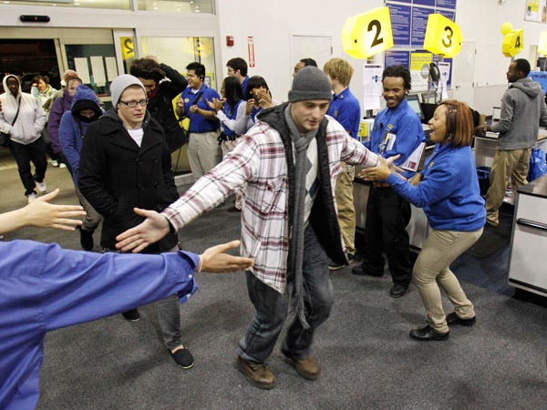 Andrew Lapchynski, 22, is greeted by employees as he enters Best Buy Friday in Mayfield Heights, Ohio. Lapchynski came into the store to buy a television.