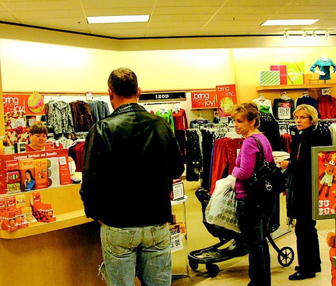 Shoppers wait patiently in line at Peebles to pay for their Black Friday purchases. Peebles opened its doors at 7 a.m. Friday to kick off the holiday shopping season.