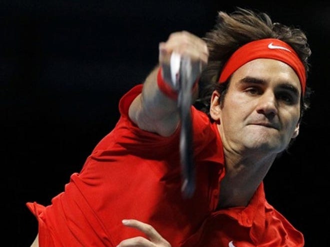 Roger Federer serves to Novak Djokovic during a semifinals match at the ATP World Tour Finals in London on Saturday.