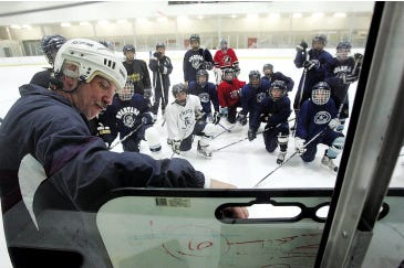 Photo by Daniel Freel/New Jersey Herald 
 
Sparta assistant ice hockey coach Jack Shaughnessy, left, goes over a play with the team during practice Wednesday at Skylands Ice World, in Hardyston.