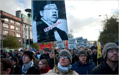 A demonstrator holds a picture of Prime Minister Brian Cowen of Ireland during a protest in Dublin on Saturday.